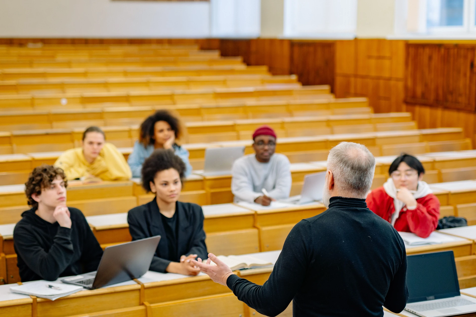A lecturer teaching students in a lecture hall